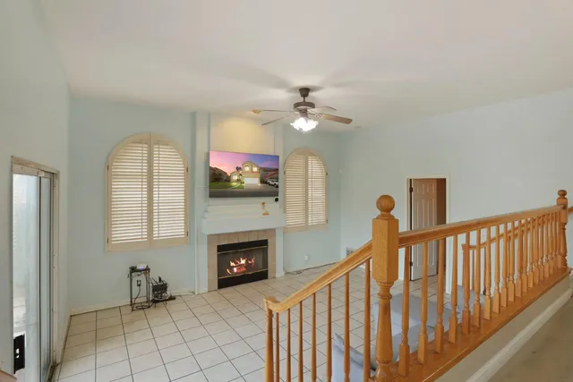 a view of an empty room with a fireplace and a window