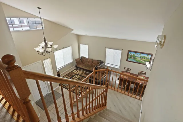 a living room with furniture and a chandelier
