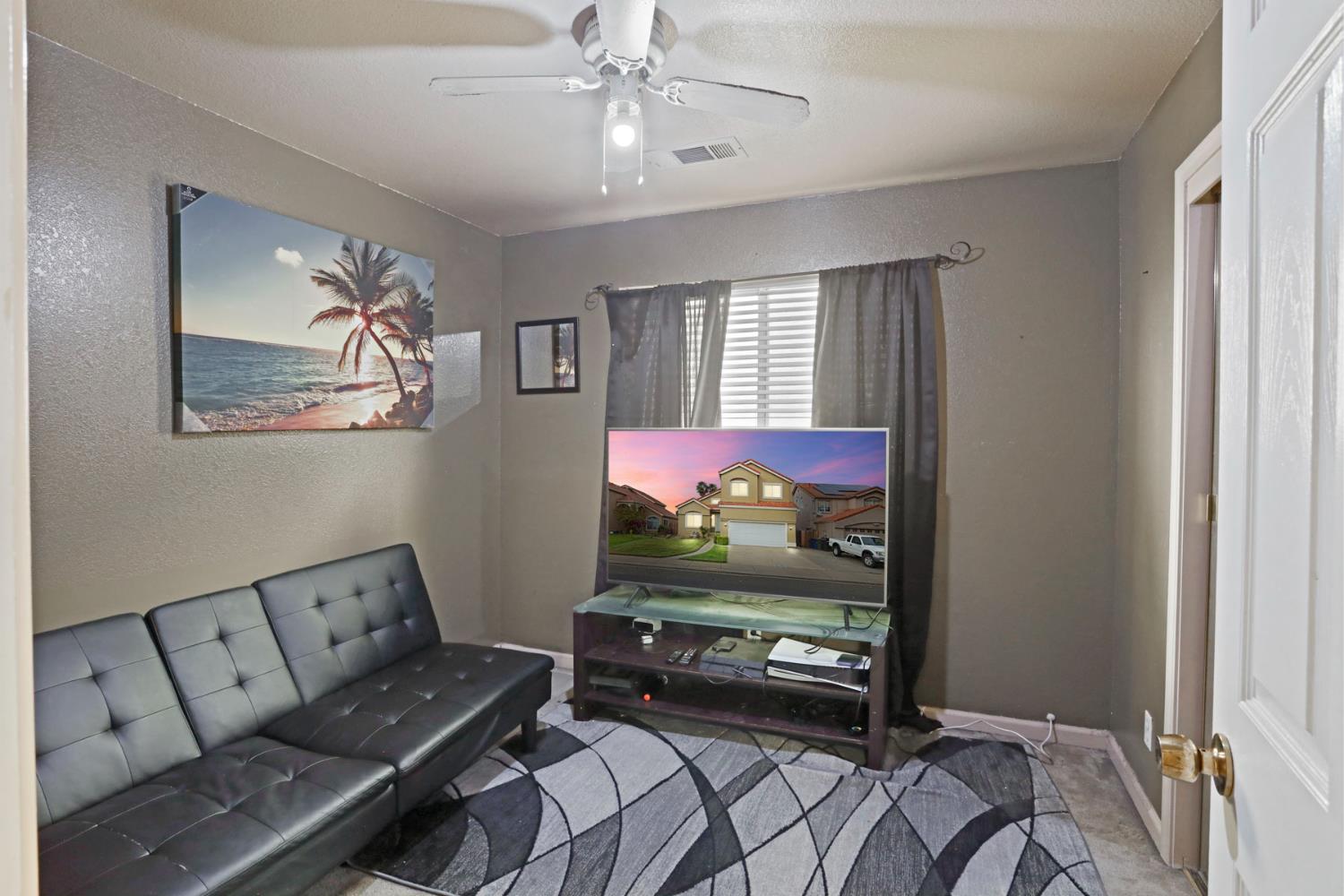 1725 Mark Mead Lane Modesto, CA 95356 - Photo 27 of 52 a living room with furniture and a flat screen tv
