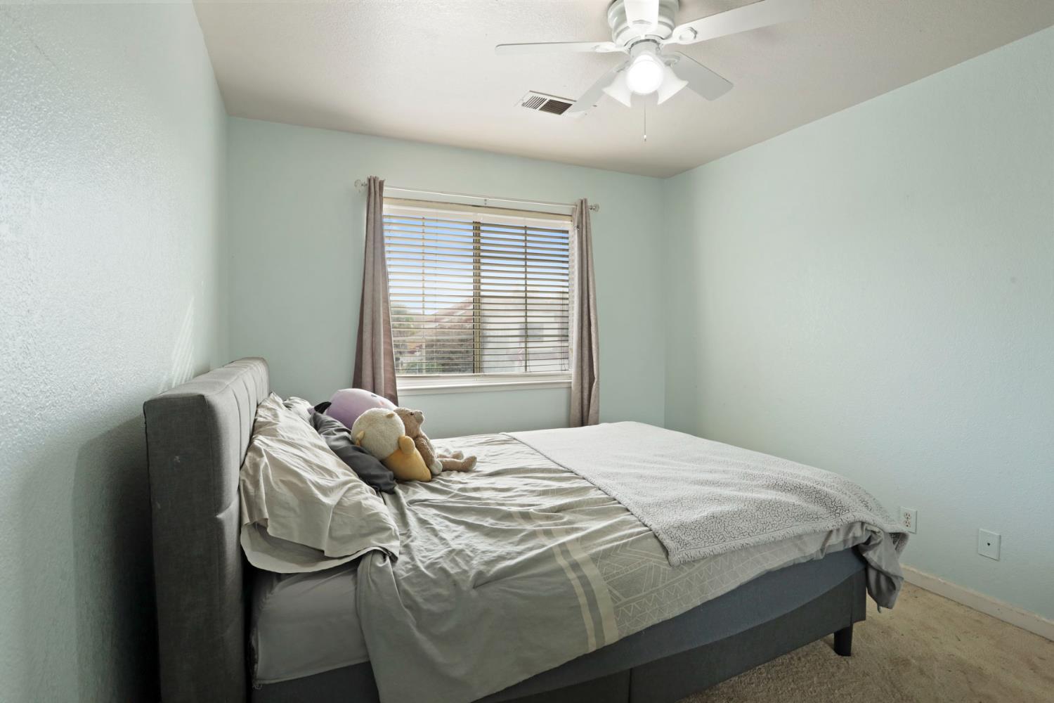 1725 Mark Mead Lane Modesto, CA 95356 - Photo 29 of 52 a bedroom with a bed and window