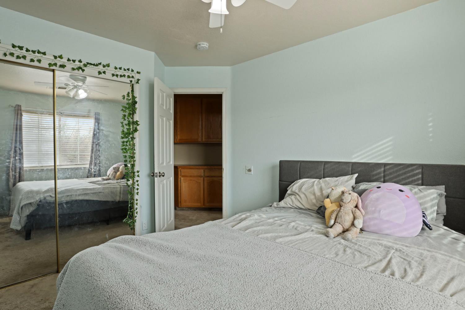 1725 Mark Mead Lane Modesto, CA 95356 - Photo 30 of 52 a bedroom with a bed and a glass door