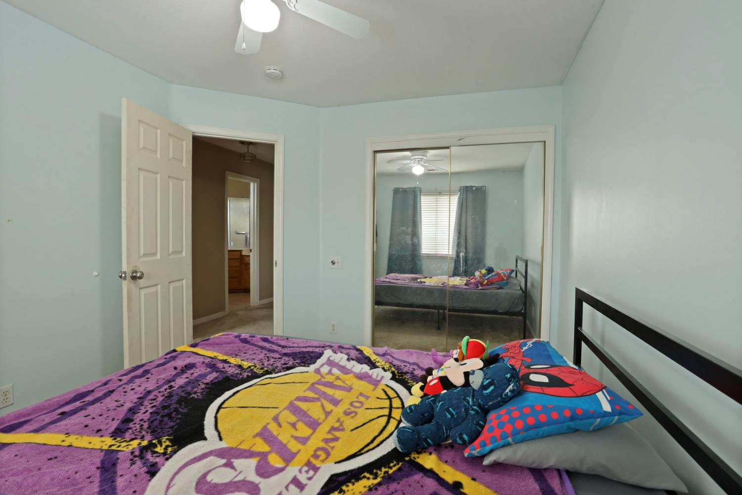 1725 Mark Mead Lane Modesto, CA 95356 - Photo 32 of 52 a bedroom with bed and a chandelier