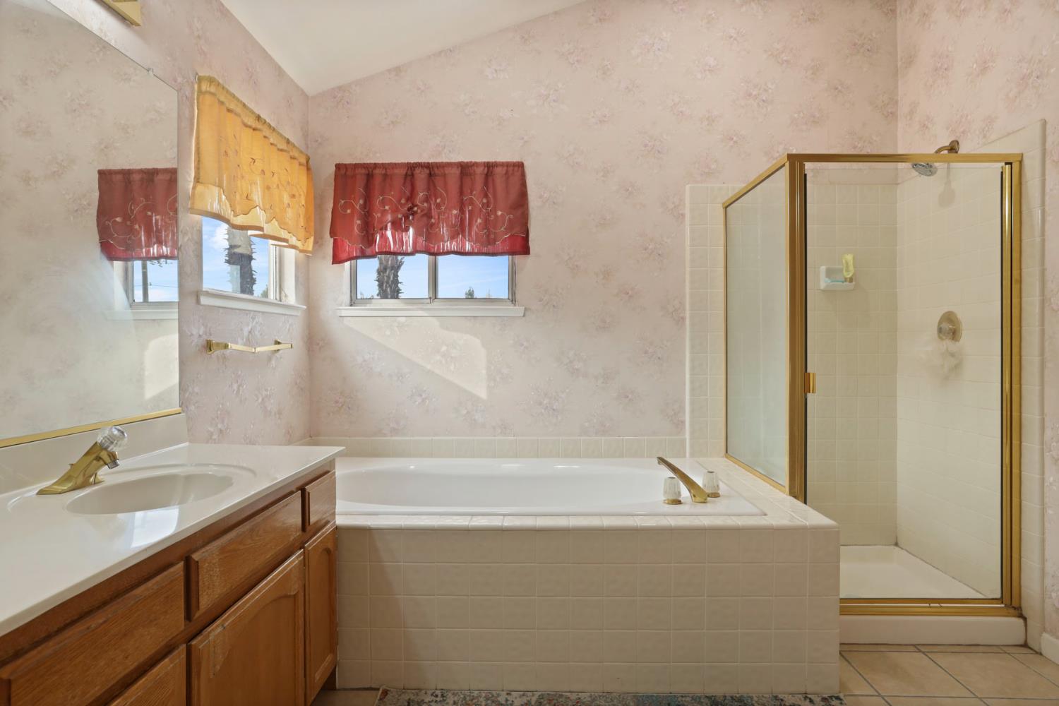 1725 Mark Mead Lane Modesto, CA 95356 - Photo 39 of 52 a bathroom with a tub a sink and a shower