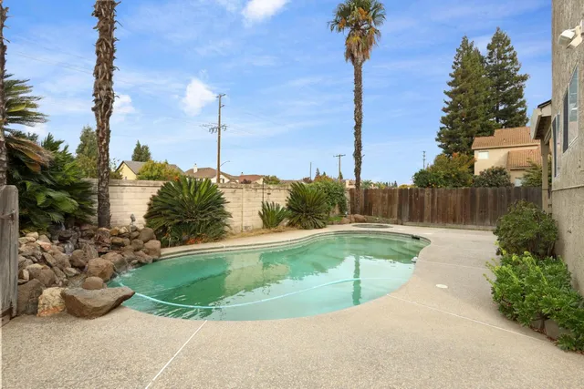 a view of a swimming pool with a yard