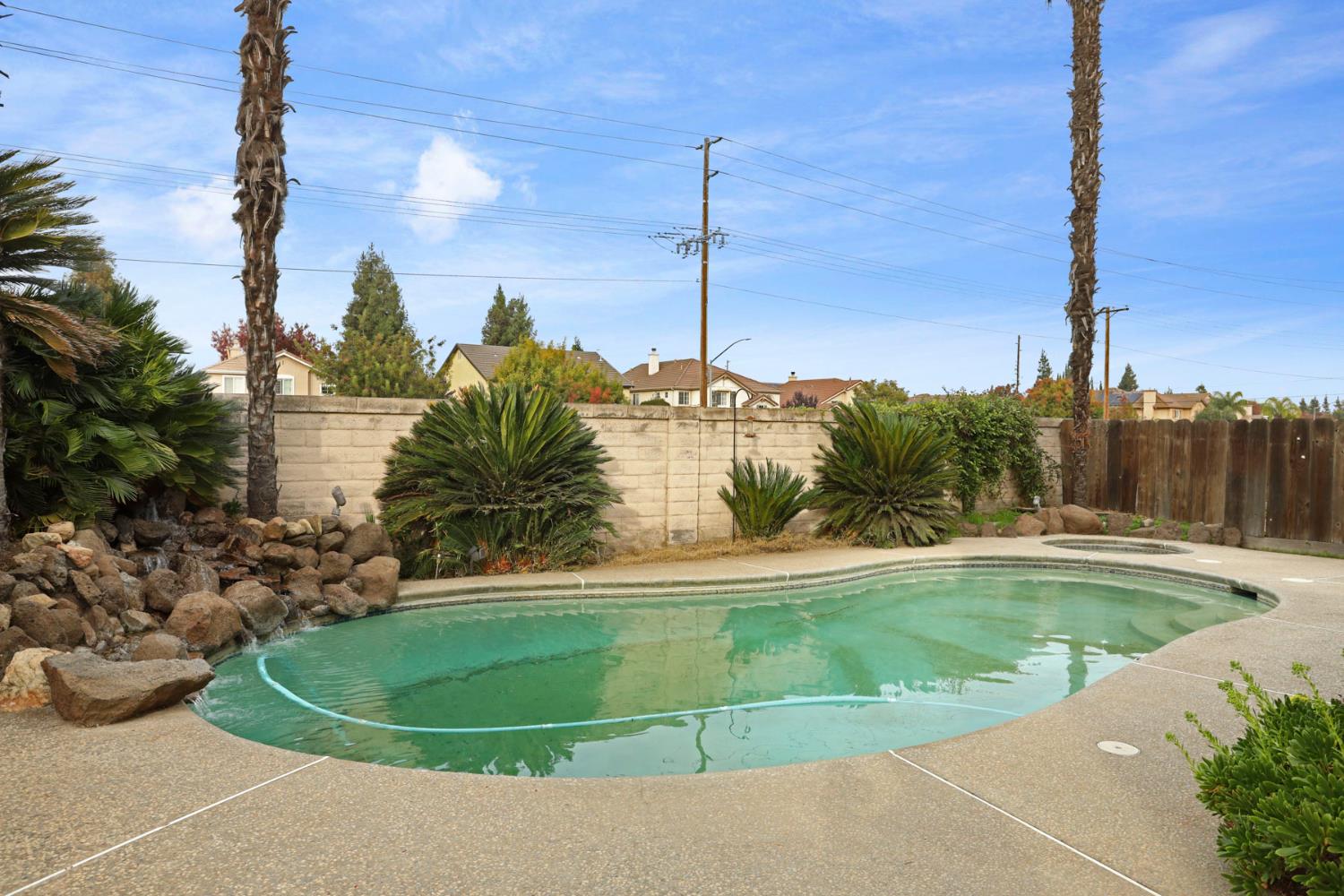 1725 Mark Mead Lane Modesto, CA 95356 - Photo 45 of 52 a view of a swimming pool with a yard