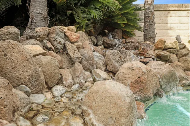 a view of a house with backyard and sitting area