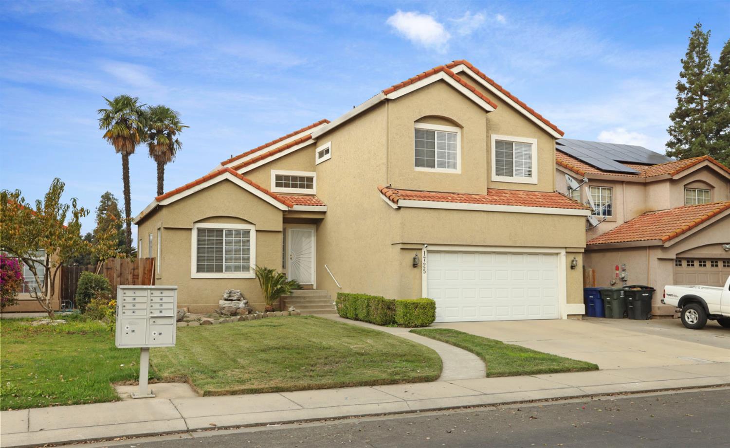 1725 Mark Mead Lane Modesto, CA 95356 - Photo 49 of 52 a front view of a house with a yard and garage