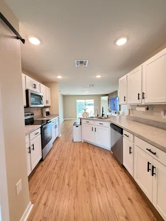 a kitchen with a sink stove and cabinets