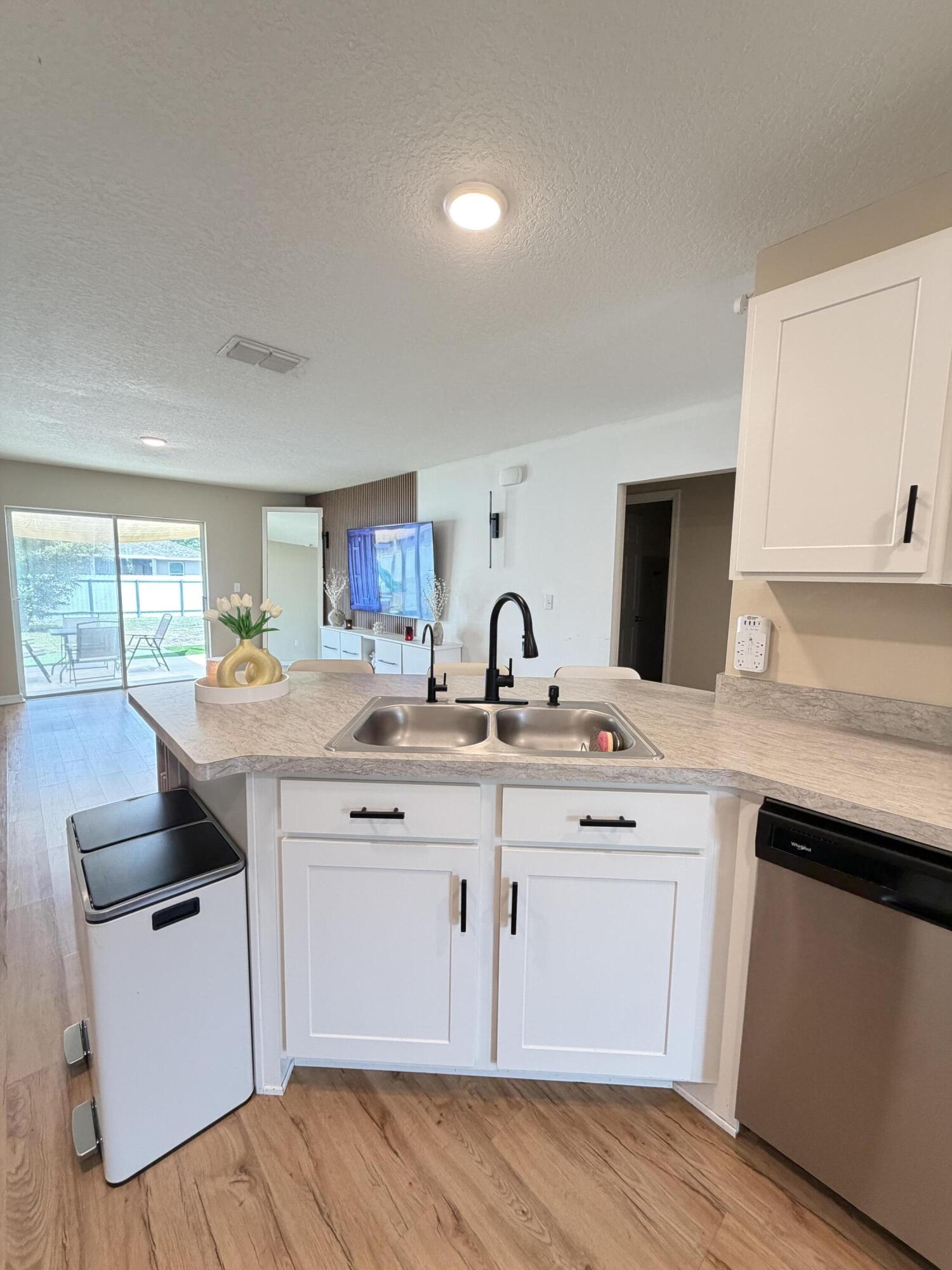 4249 Southwest Whitebread Road Port St. Lucie, FL 34953 - Photo 12 of 43 a kitchen with a sink stove and cabinets