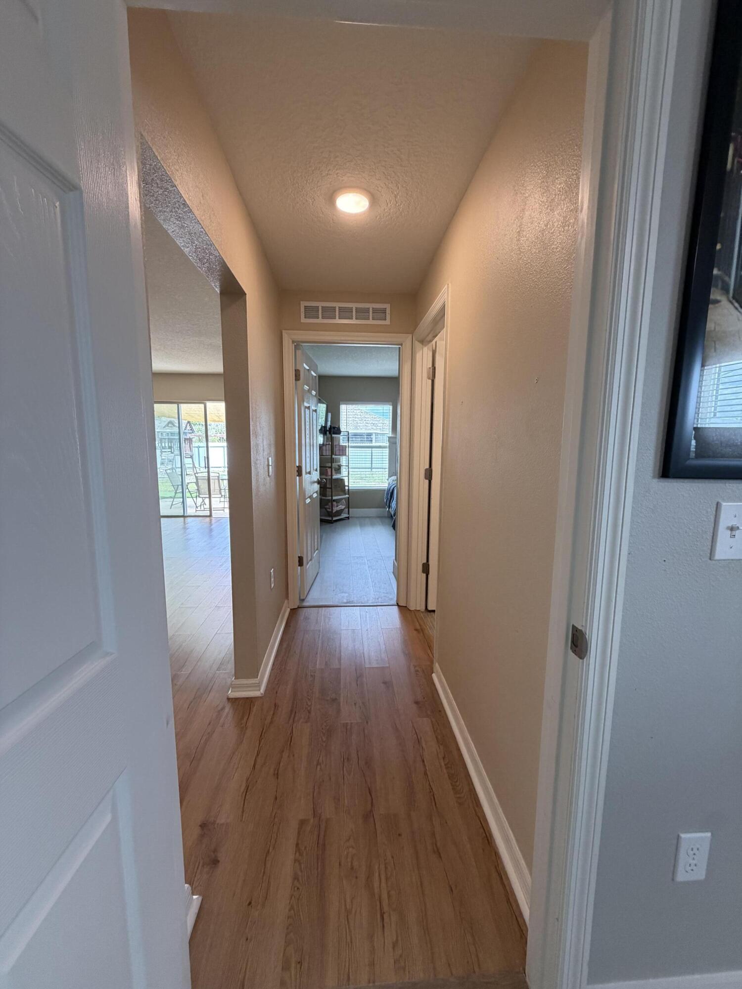 4249 Southwest Whitebread Road Port St. Lucie, FL 34953 - Photo 15 of 43 a view of a hallway with wooden floor and staircase