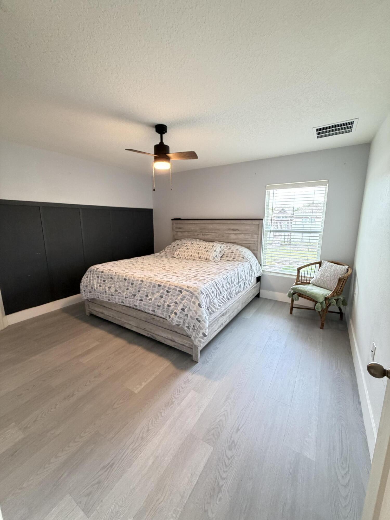 4249 Southwest Whitebread Road Port St. Lucie, FL 34953 - Photo 17 of 43 a bedroom with a bed and furniture