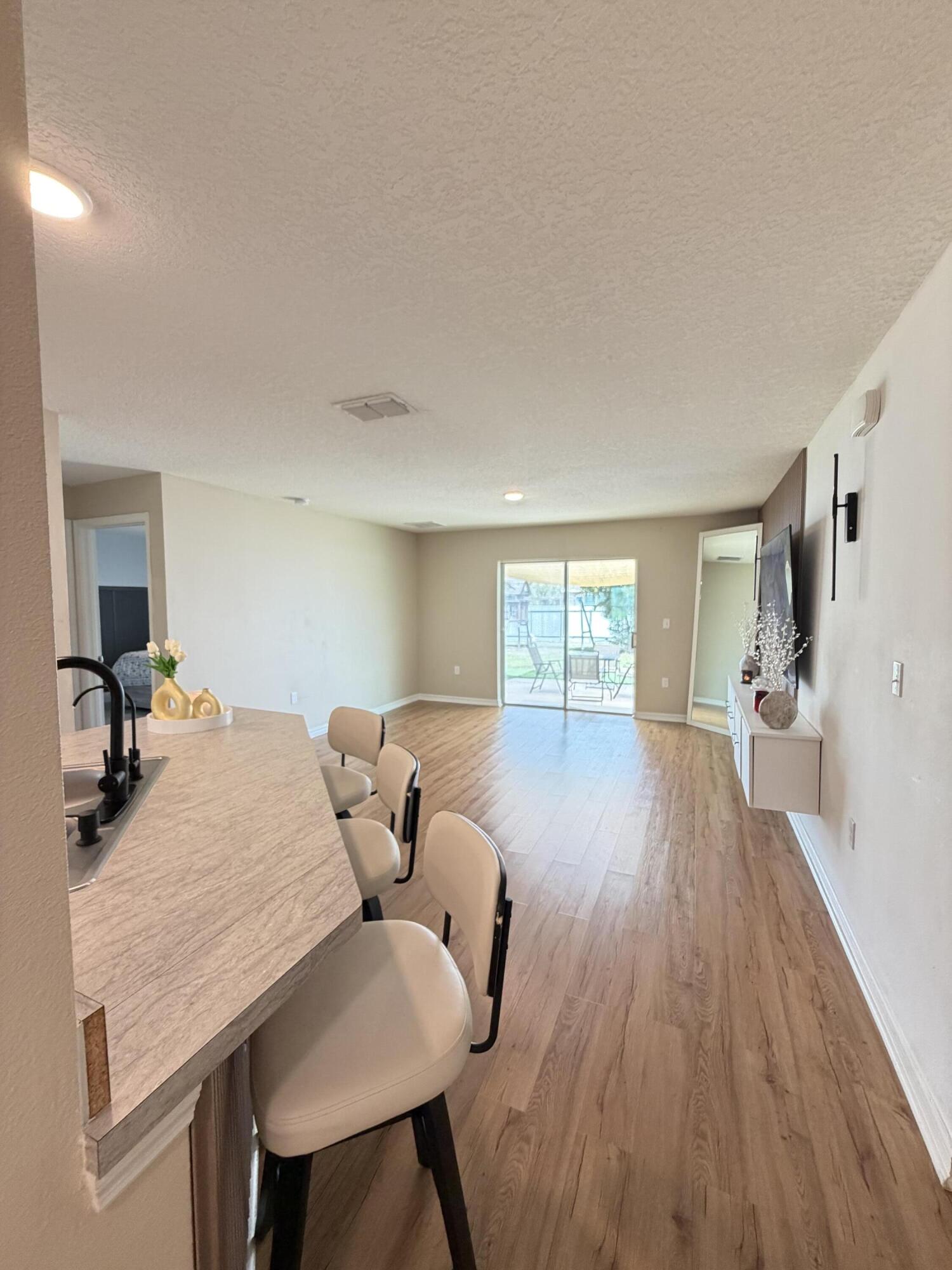 4249 Southwest Whitebread Road Port St. Lucie, FL 34953 - Photo 2 of 43 a view of a livingroom with furniture wooden floor and a window