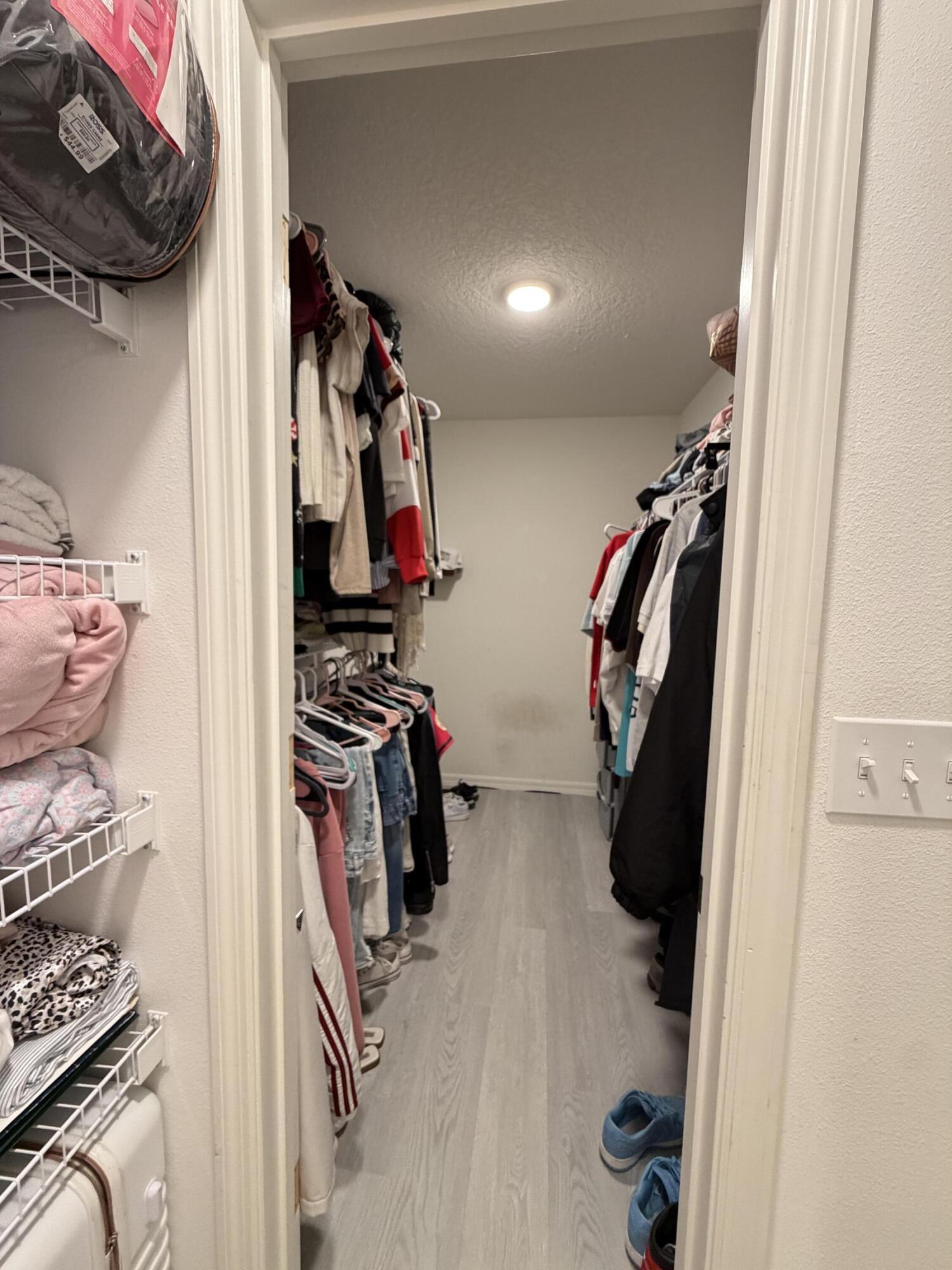 4249 Southwest Whitebread Road Port St. Lucie, FL 34953 - Photo 22 of 43 a view of walk in closet with clothes and shoes