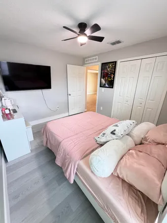 a bedroom with a bed and a chandelier
