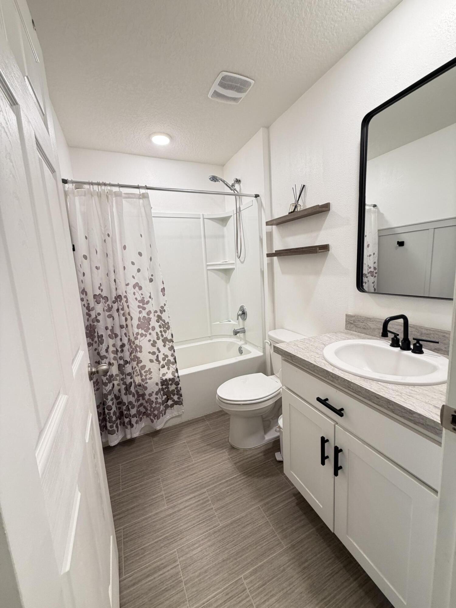 4249 Southwest Whitebread Road Port St. Lucie, FL 34953 - Photo 27 of 43 a bathroom with a double vanity sink toilet and shower