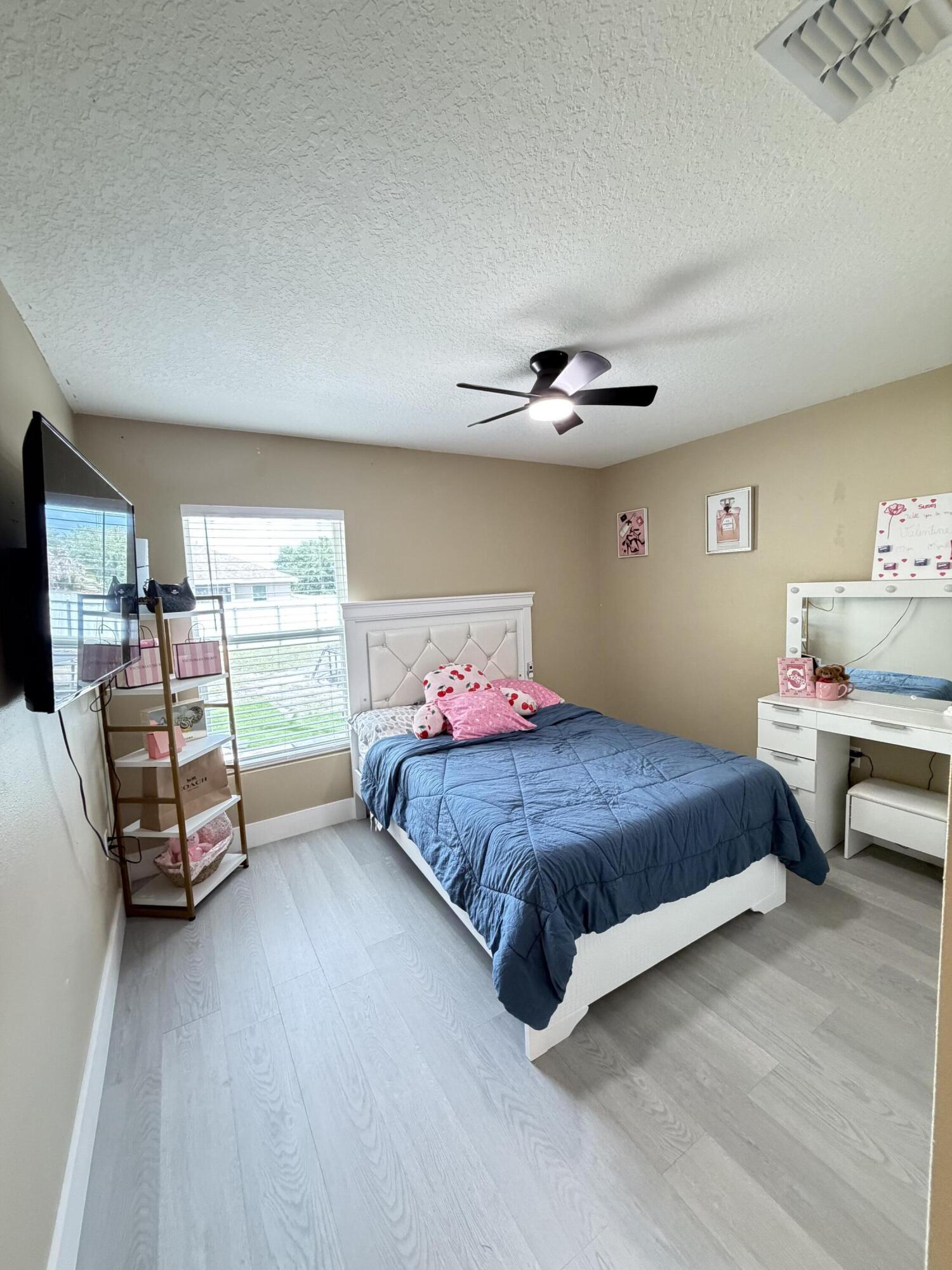 4249 Southwest Whitebread Road Port St. Lucie, FL 34953 - Photo 30 of 43 a bedroom with a bed and a window