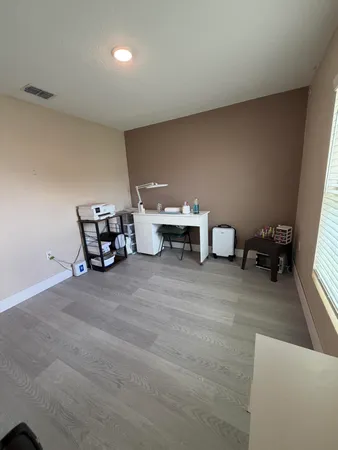 a view of a livingroom with a chair and a window