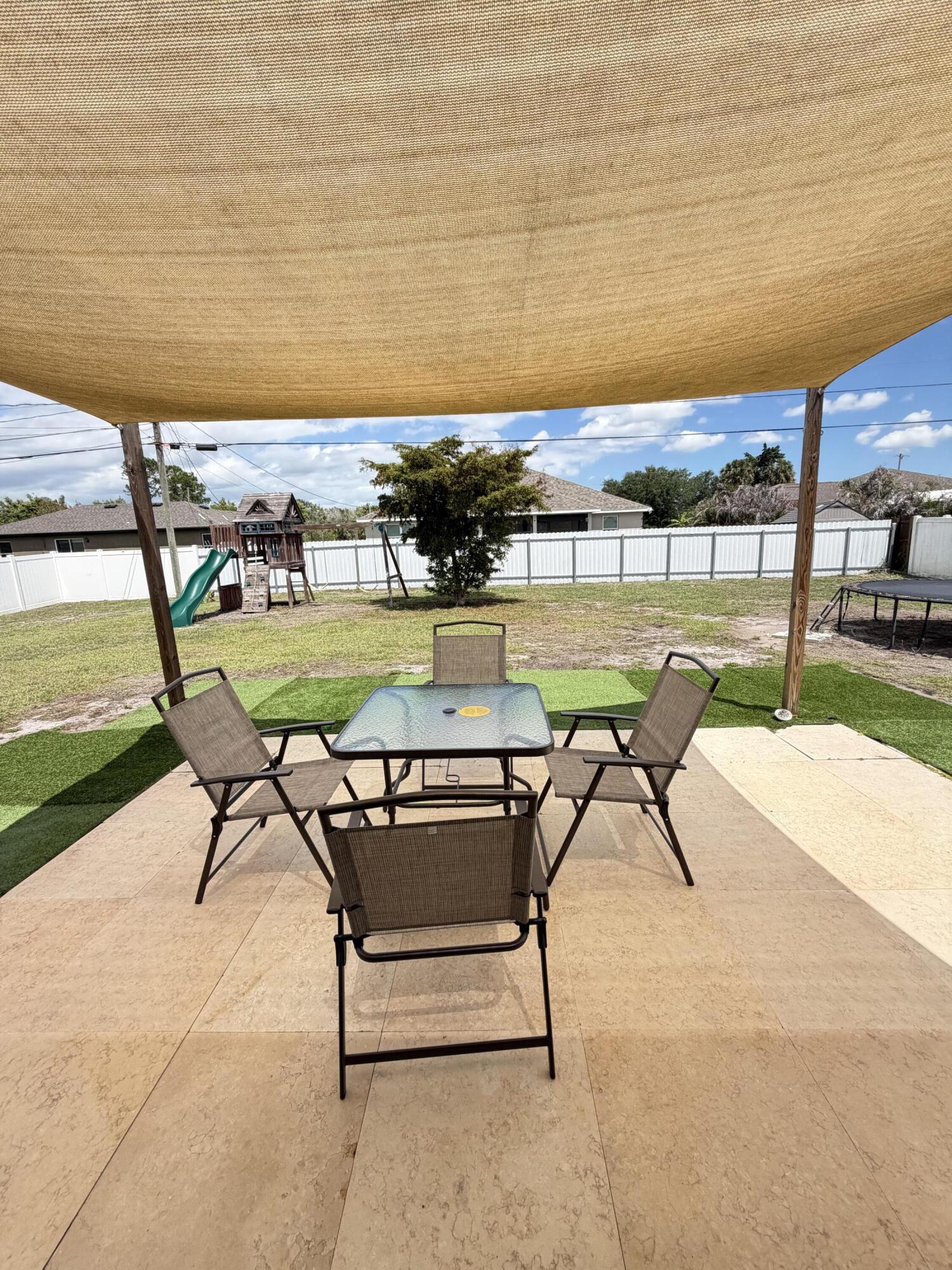 4249 Southwest Whitebread Road Port St. Lucie, FL 34953 - Photo 33 of 43 a view of a swimming pool with a lounge chairs