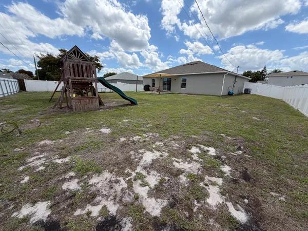 a view of a big yard with table and chairs