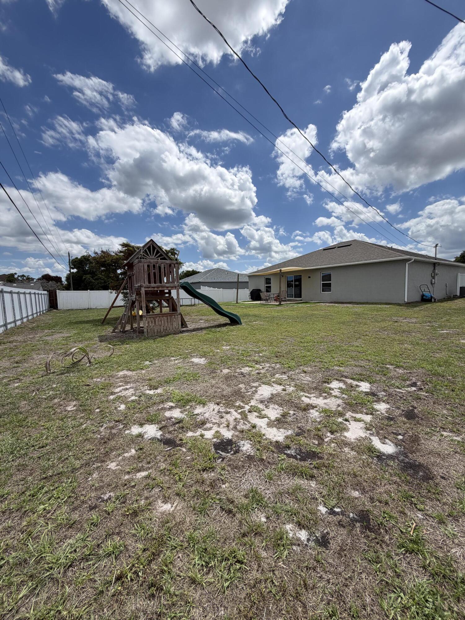 4249 Southwest Whitebread Road Port St. Lucie, FL 34953 - Photo 35 of 43 a view of a big yard with table and chairs