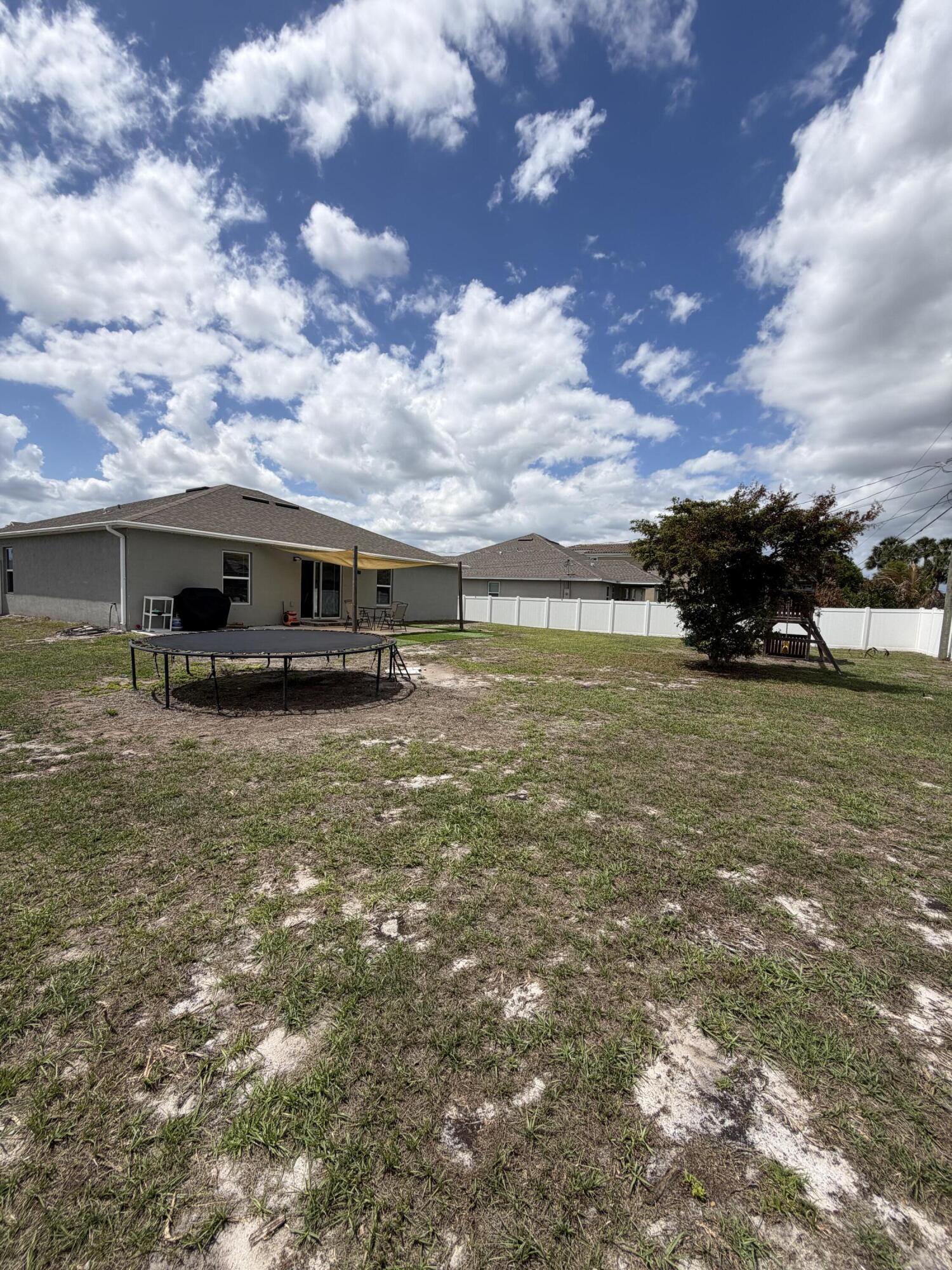 4249 Southwest Whitebread Road Port St. Lucie, FL 34953 - Photo 36 of 43 a view of a house with yard and sitting area