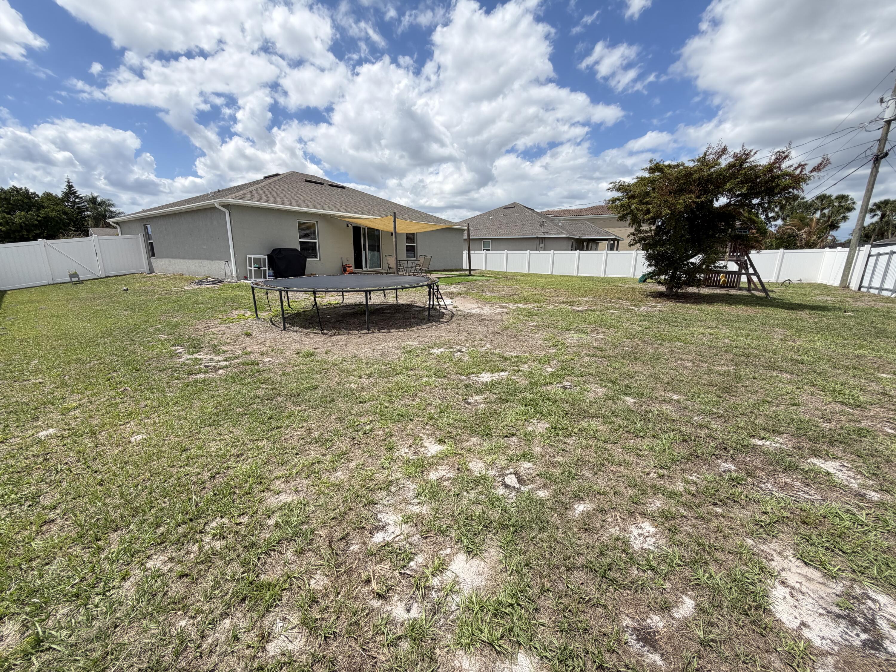 4249 Southwest Whitebread Road Port St. Lucie, FL 34953 - Photo 37 of 43 a front view of a house with garden
