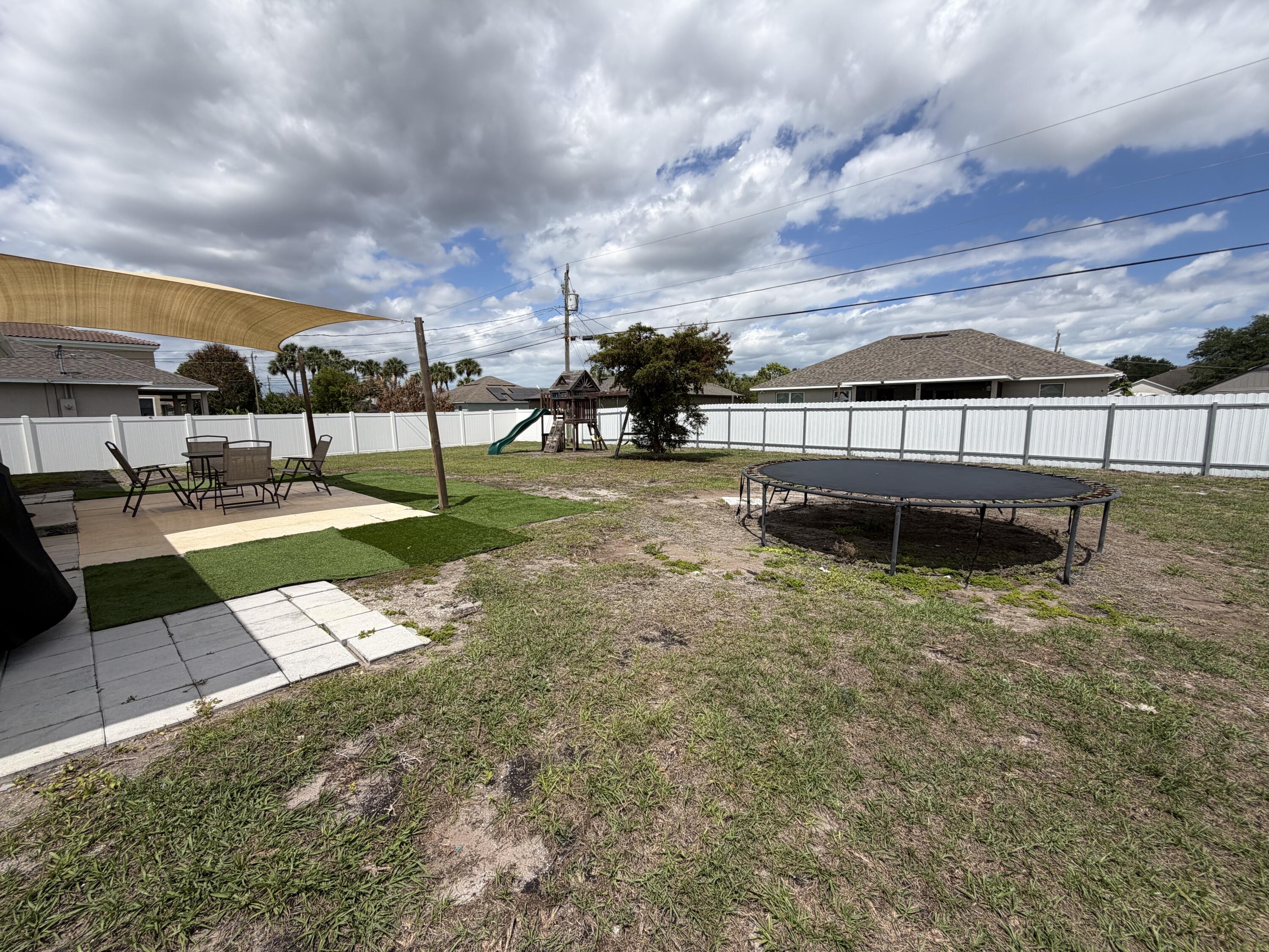 4249 Southwest Whitebread Road Port St. Lucie, FL 34953 - Photo 40 of 43 a view of a backyard with sitting area