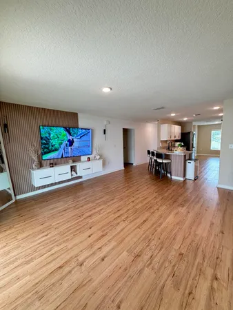a big room with wooden floor and windows