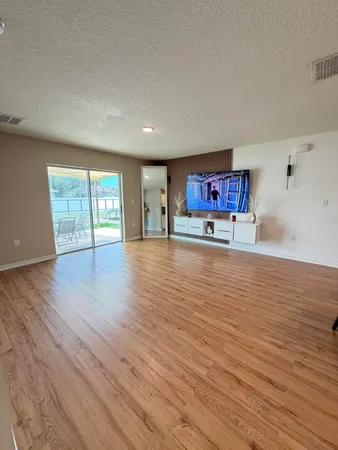 a large kitchen with a table and chairs