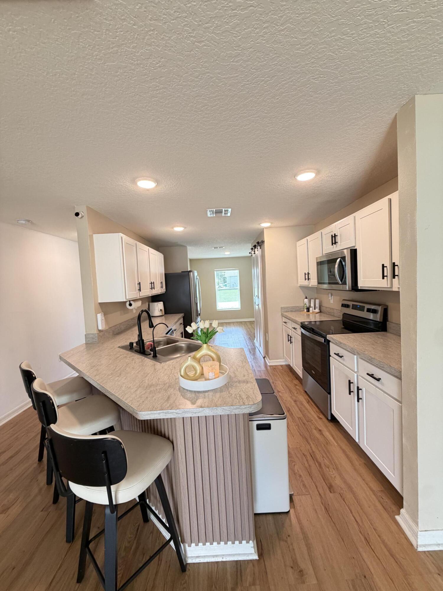 4249 Southwest Whitebread Road Port St. Lucie, FL 34953 - Photo 7 of 43 a large kitchen with a table and chairs