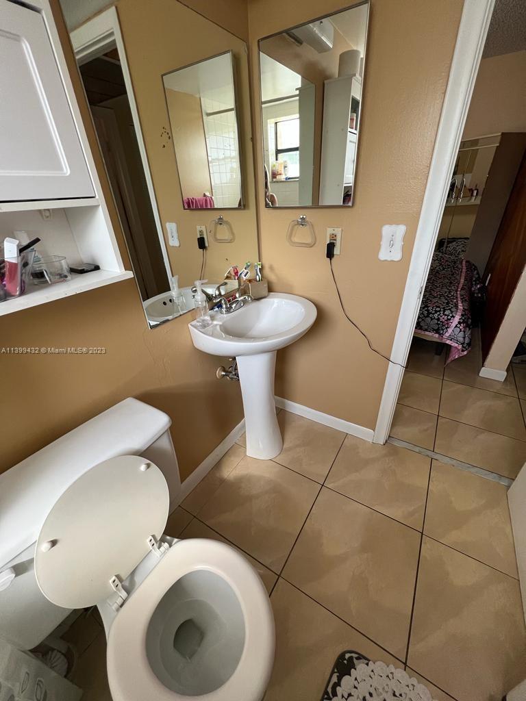 Hialeah Hialeah, FL 33016 - Photo 12 of 14 a bathroom with a toilet sink and mirror