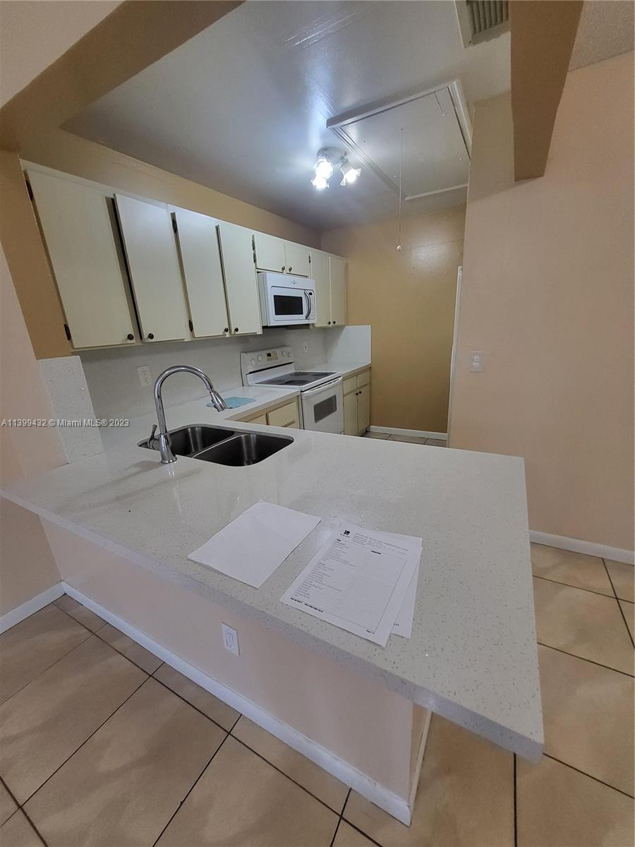 Hialeah Hialeah, FL 33016 - Photo 6 of 14 a kitchen with stainless steel appliances a sink stove and cabinets