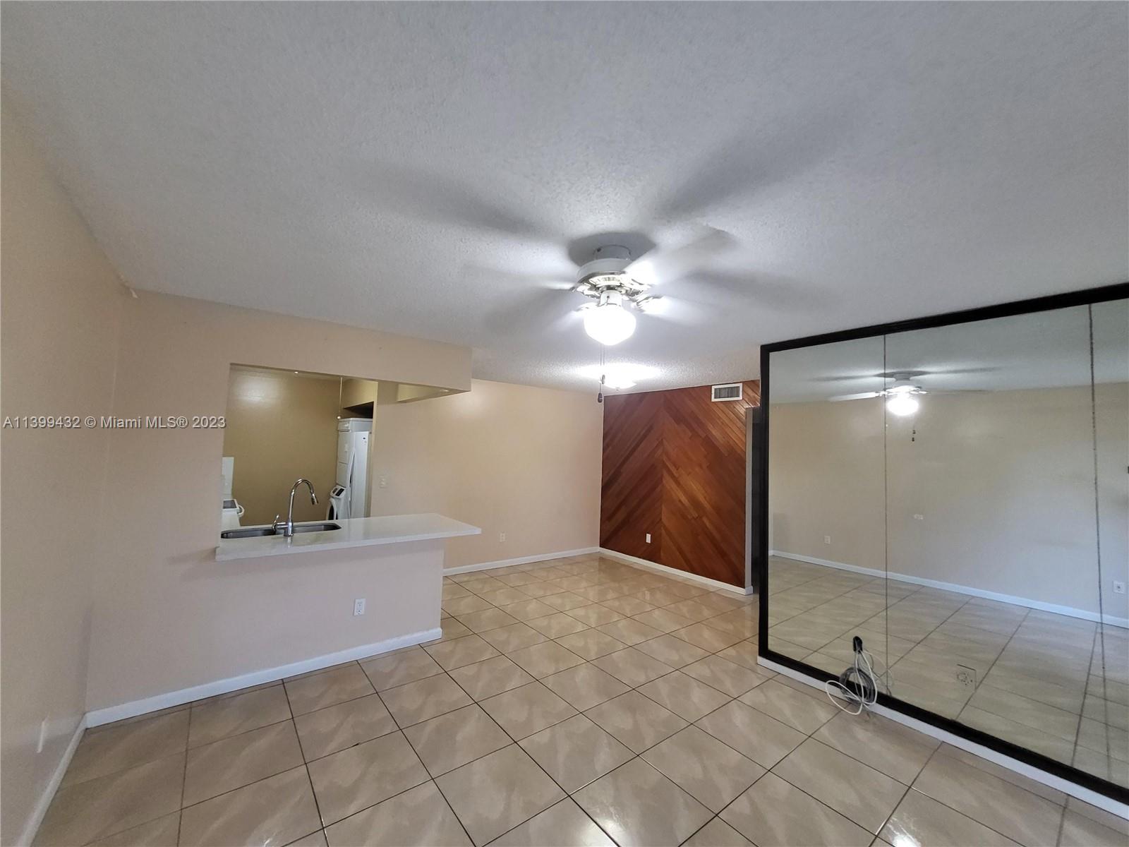 Hialeah Hialeah, FL 33016 - Photo 9 of 14 a view of an empty room with wooden floor and a cabinet