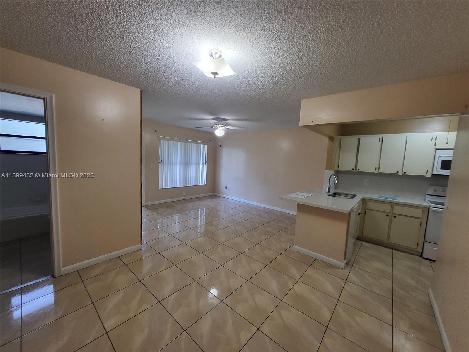 Hialeah Hialeah, FL 33016 - Photo 10 of 14 a kitchen with granite countertop a sink and a stove