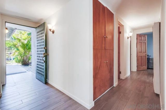 a view of hallway with wooden floor