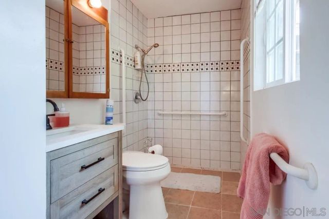 a bathroom with a toilet and shower