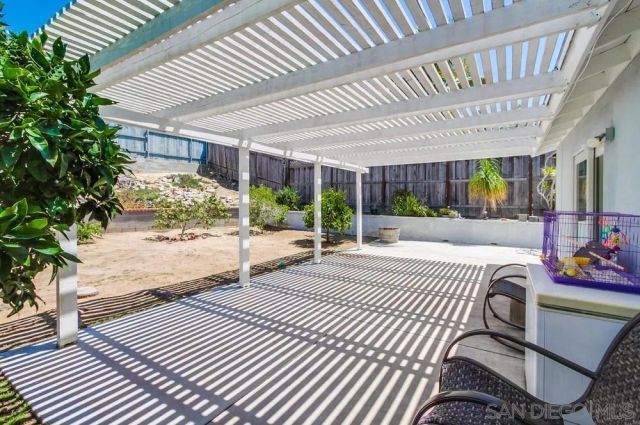 a spacious bedroom with a large bed and a potted plant