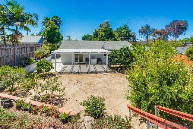 a view of a house with a yard and plants