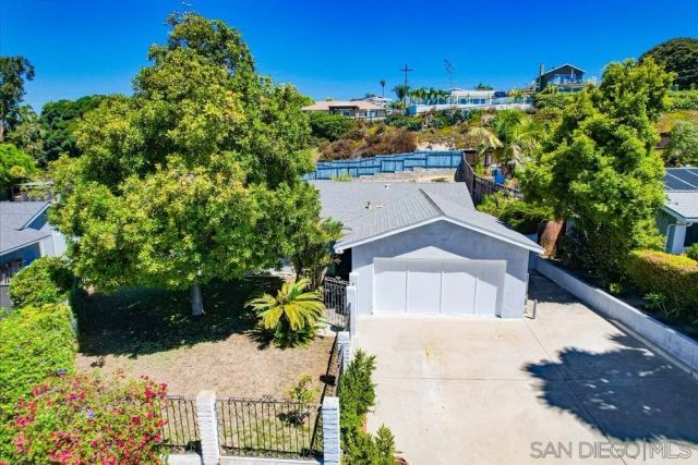a view of a house with a yard and potted plants
