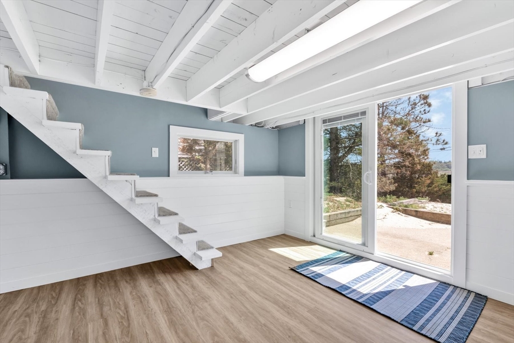 90 Salt Marsh Road East Sandwich, MA 02537 - Photo 36 of 40 a view of a big room with wooden floor and windows
