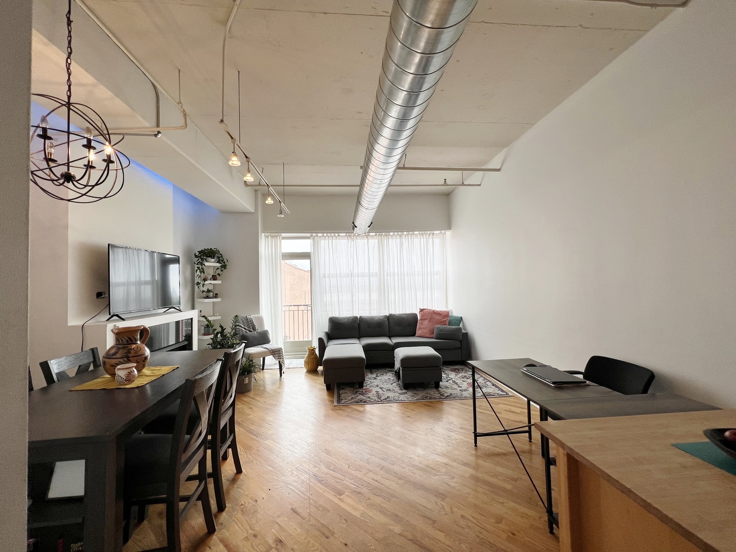 500 South Clinton Street, Unit 720 Chicago, IL 60607 - Photo 4 of 19 a living room with furniture and a chandelier