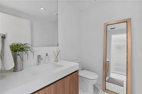 an outdoor living with furniture and city view