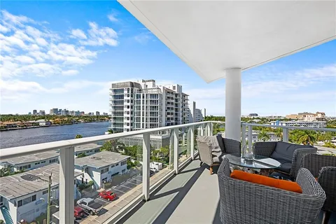 a view of city from balcony with furniture