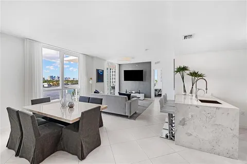 a living room with furniture a large window and a flat screen tv