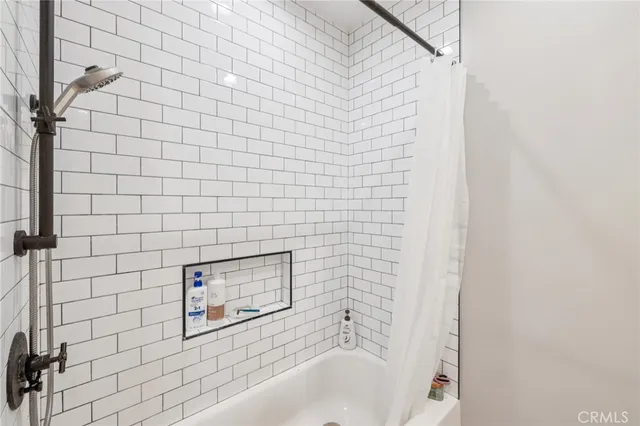 a bathroom with a bathtub and shower