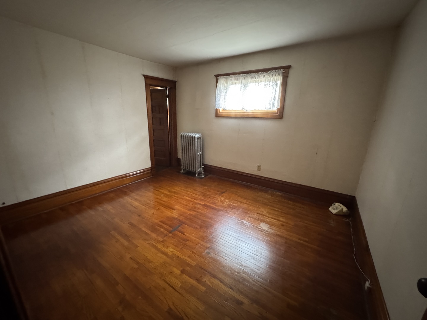 428 West Cherry Street Compton, IL 61318 - Photo 16 of 20 a view of an empty room with wooden floor and a window