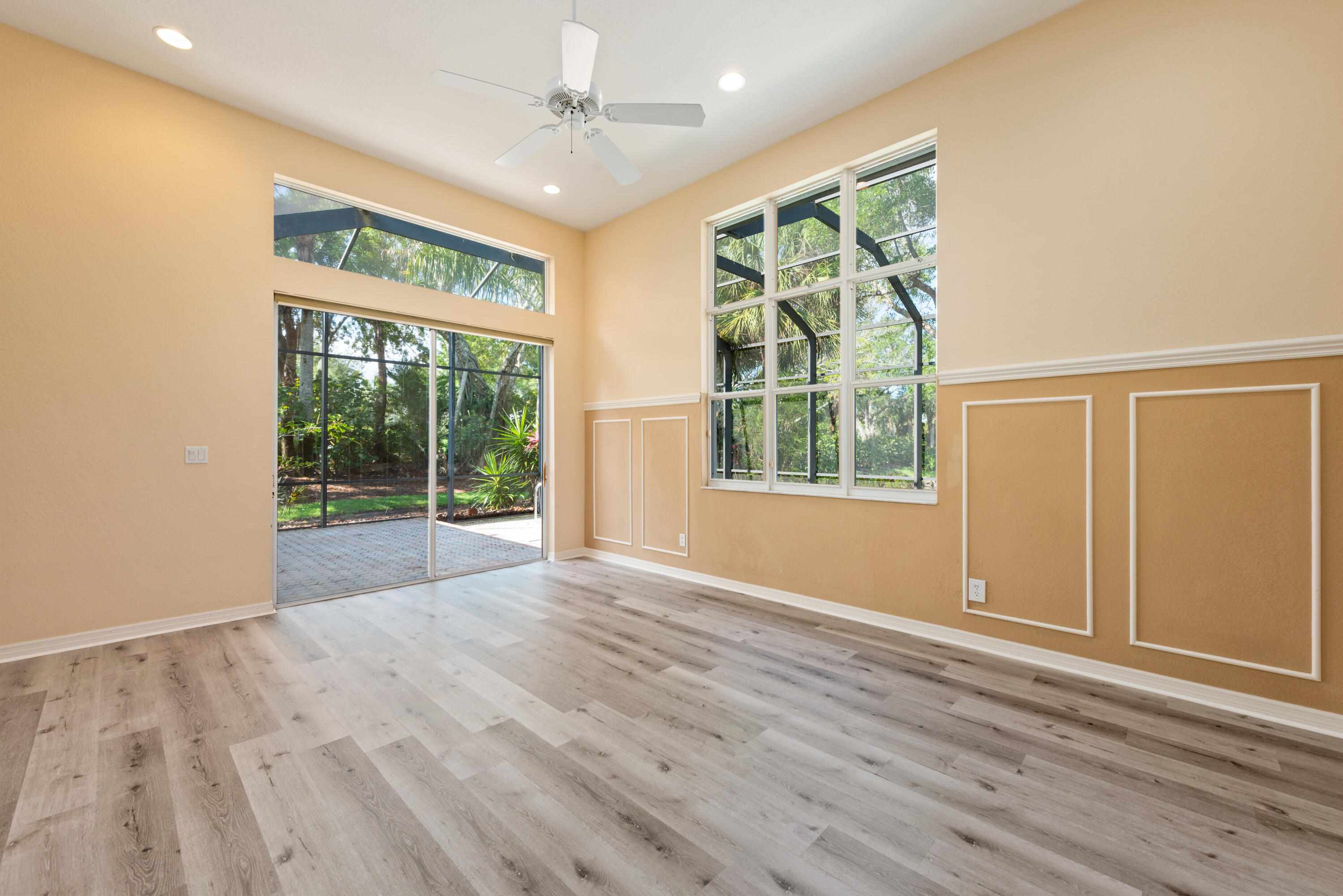 8525 Peppertree Way Naples, FL 34114 - Photo 12 of 47 a view of an empty room with wooden floor and a window