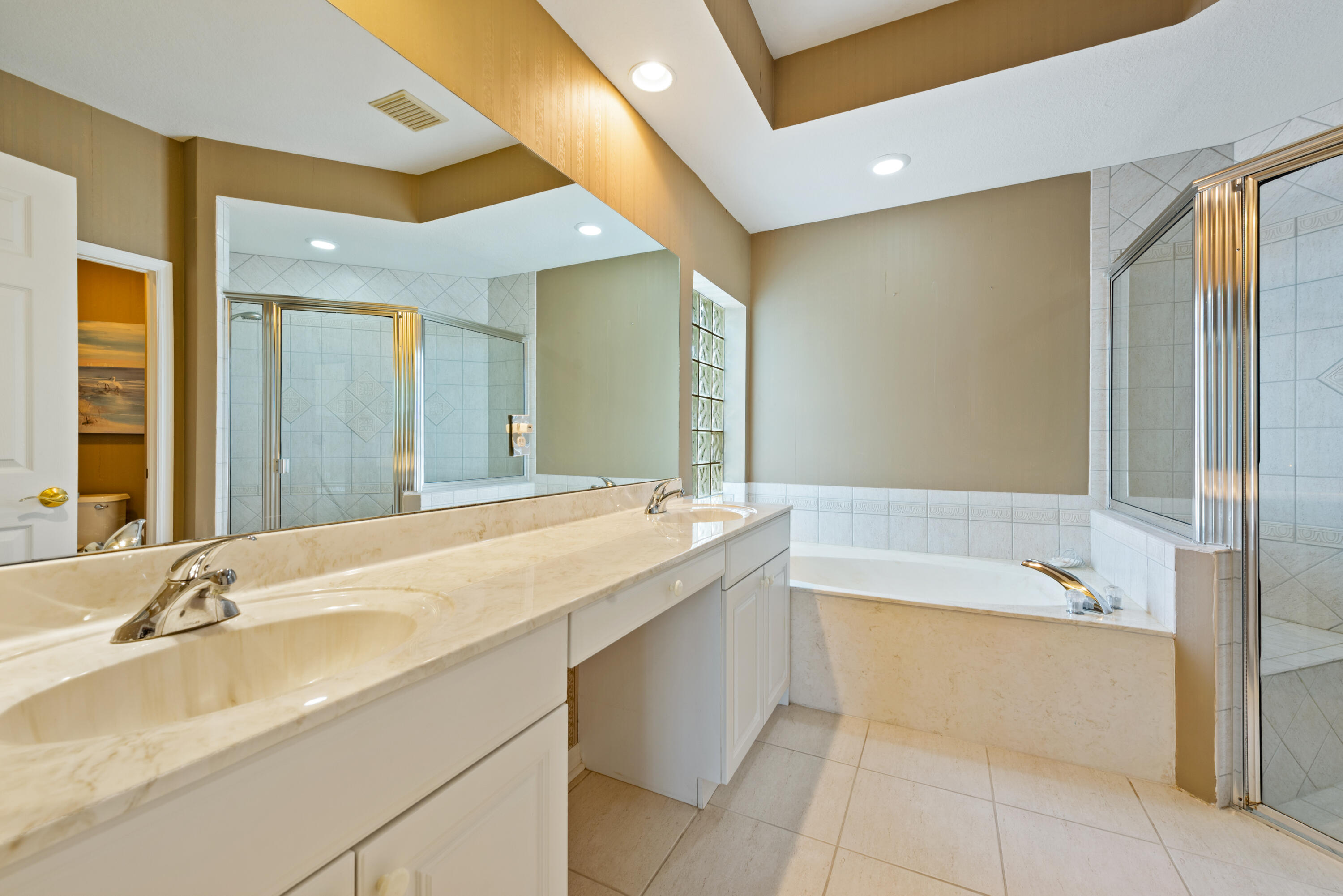 8525 Peppertree Way Naples, FL 34114 - Photo 13 of 47 a bathroom with a tub sink and mirror