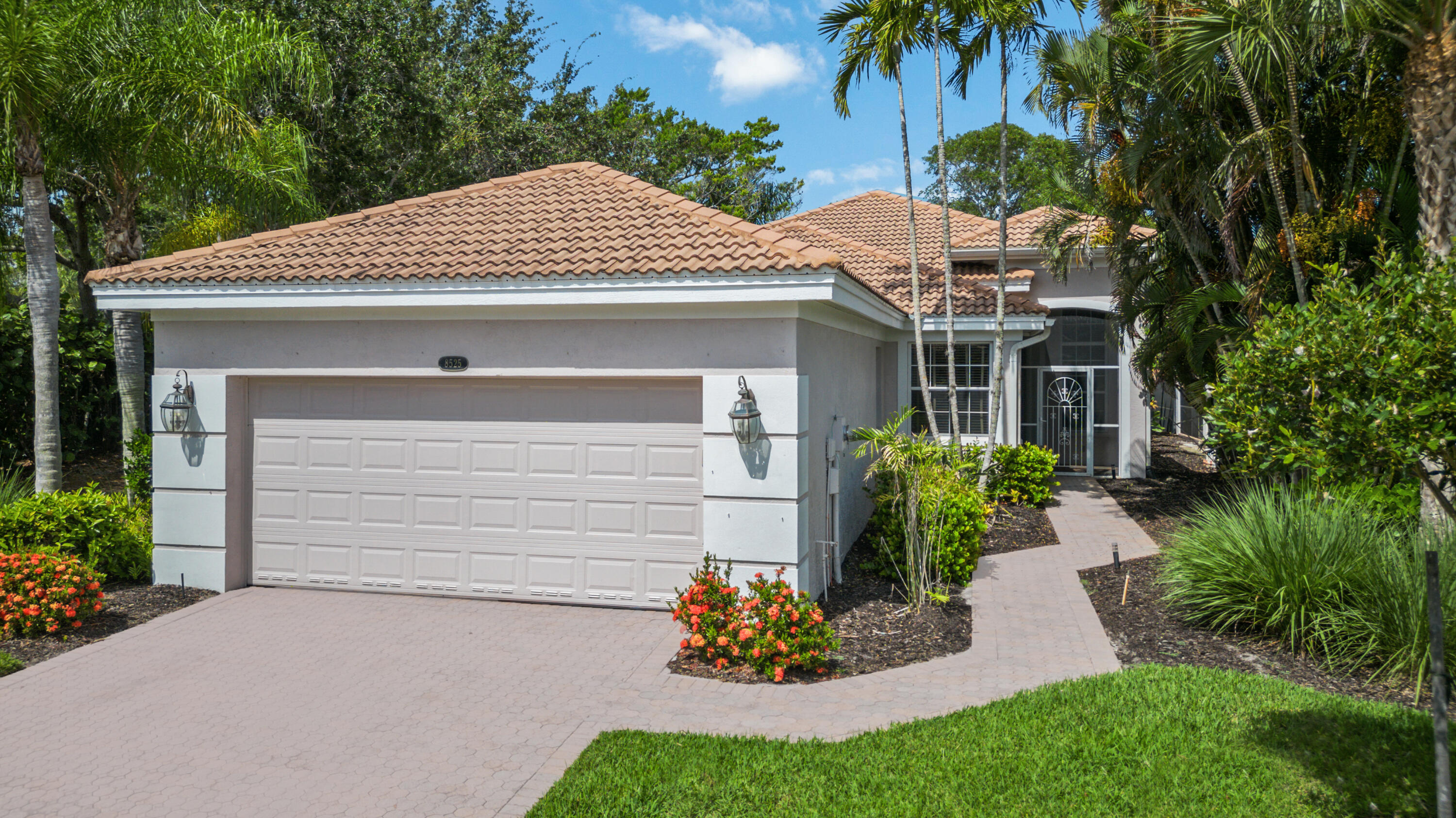 8525 Peppertree Way Naples, FL 34114 - Photo 2 of 47 a front view of a house with a garden