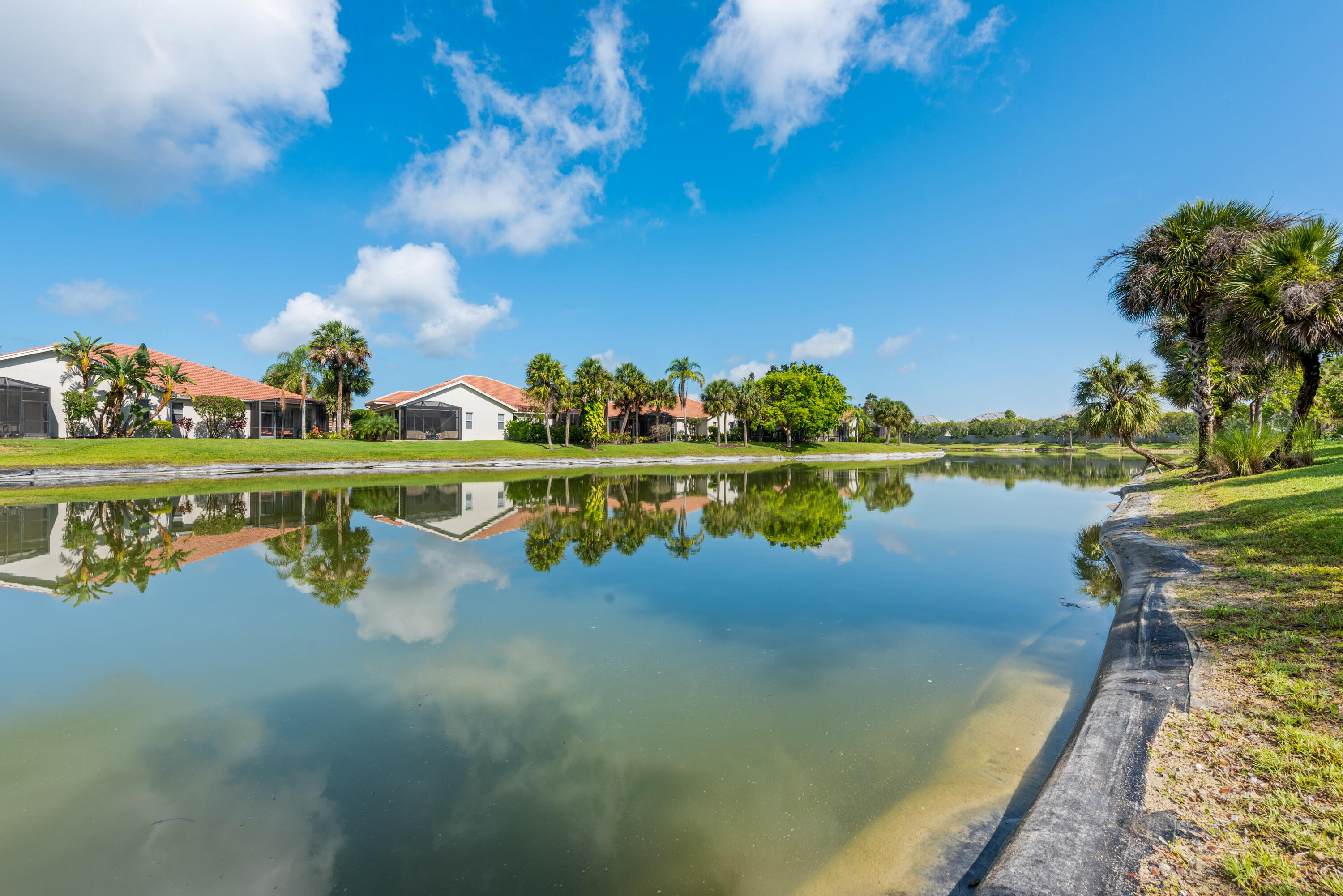 8525 Peppertree Way Naples, FL 34114 - Photo 25 of 47 a view of a lake with houses in the background